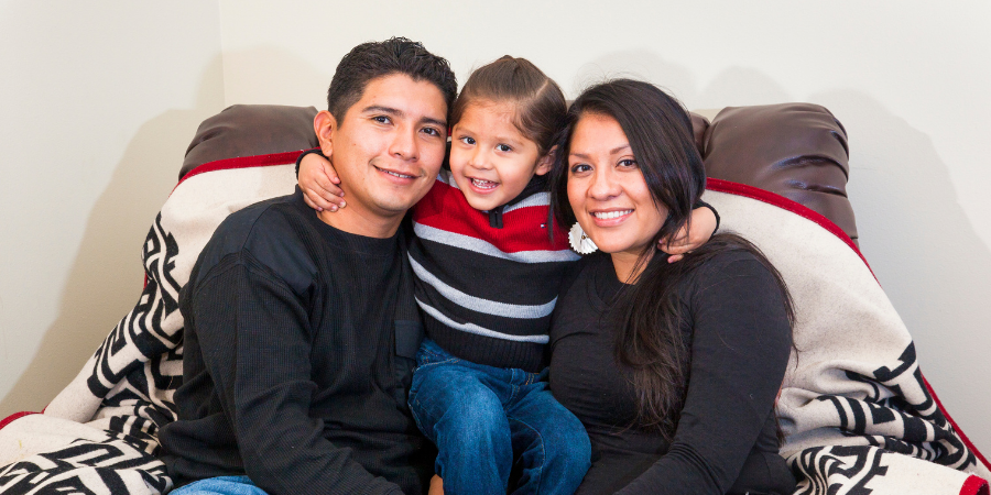 a native american father, child, and mother