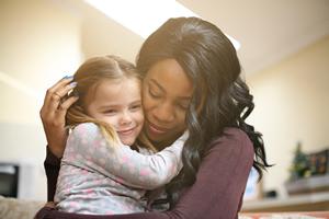woman hugging child