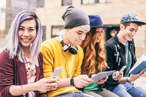 group of teenagers on their phones